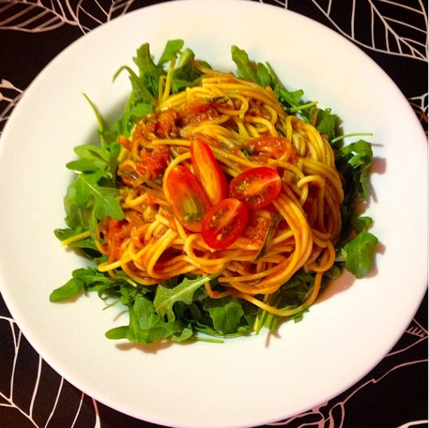 healthyhappyjess Corn Pasta with Zucchini zoodles and tomatoes on top of fresh arugula.